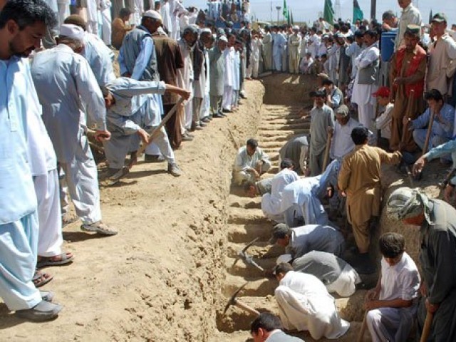 Shia Muslims dig graves for their community members at a graveyard in Quetta, Sept 21, 2011, after their killing in an attack by gunmen. PHOTO: AFP