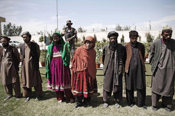 afghansecurityforcespresenttothemediatalibanmilitantscladinafghanwomendresses