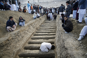 A man prepares graves for the burial of victims of Saturday's bomb attack in a Shi'ite Muslim area, in the Pakistani city of Quetta February 17, 2013. Pakistan's unpopular government, which is gearing up for elections expected within months, faced growing anger on Sunday for failing to deliver stability after the sectarian bombing in the city of Quetta killed 81 people. REUTERS/Naseer Ahmed (PAKISTAN - Tags: CIVIL UNREST CRIME LAW POLITICS RELIGION TPX IMAGES OF THE DAY) - RTR3DWYP