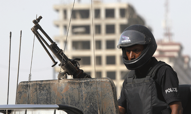 A Policeman stands gaurd in Karachi --Reuters