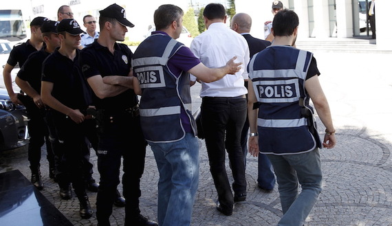 Police officers frisk an employee of the Koza Ipek Group during a raid at the company's office in Ankara, Turkey, September 1, 2015. Turkish police raided the offices of the conglomerate with close links to U.S.-based Muslim cleric Fethullah Gulen, an ally-turned-foe of President Tayyip Erdogan, company officials said on Tuesday. REUTERS/Umit Bektas - RTX1QKD8