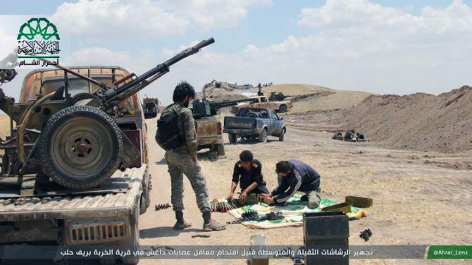 In this image posted on the Twitter page of Ahrar al-Sham on Aug. 13, 2015, fighters from Ahrar al-Sham prepare weapons ahead of an attack on Islamic State group positions in Aleppo province, Syria. The group has vowed to defeat what it calls Russian "occupation" of Syria after Moscow began launching airstrikes on insurgents last week. (Ahrar al-Sham Twitter page via AP)