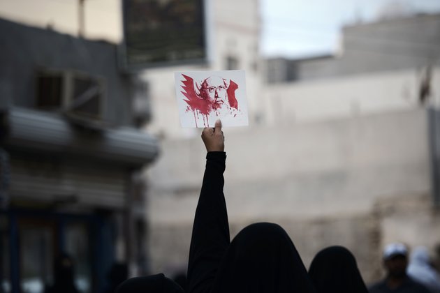 A Bahraini woman holds a placard bearing a portrait of prominent Shiite Muslim cleric Nimr al-Nimr during a protest in the village of Jidhafs, west of Manama, against his execution by Saudi authorities, on January 2, 2016. Nimr was a driving force of the protests that broke out in 2011 in the kingdom's east, an oil-rich region where the Shiite minority of an estimated two million people complains of marginalisation. AFP PHOTO / MOHAMMED AL-SHAIKH / AFP / MOHAMMED AL-SHAIKH (Photo credit should read MOHAMMED AL-SHAIKH/AFP/Getty Images)
