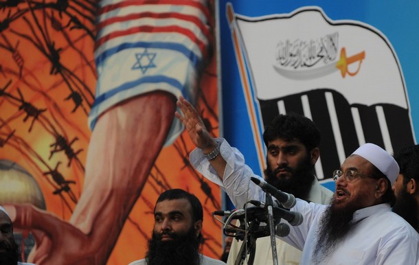 Hafiz Saeed (R), leader of banned charity organisation Jamaat-ud-Dawa, speaks at a rally in Lahore on June 13, 2010 against the Israeli deadly raid on aid ships bound for Gaza. Nine Turks were killed by Israeli commandos who boarded a Turkish vessel carrying humanitarian aid to Gaza, which is under an Israeli blockade. AFP PHOTO/Arif ALI (Photo credit should read Arif Ali/AFP/Getty Images)