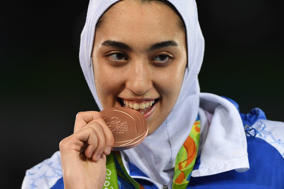 Iran's Kimia Alizadeh Zenoorin poses with her bronze medal on the podium after the womens taekwondo event in the -57kg category as part of the Rio 2016 Olympic Games, on August 18, 2016, at the Carioca Arena 3, in Rio de Janeiro. / AFP / Kirill KUDRYAVTSEV (Photo credit should read KIRILL KUDRYAVTSEV/AFP/Getty Images)
